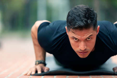 Young man exercising outdoors. Sports lifestyle.