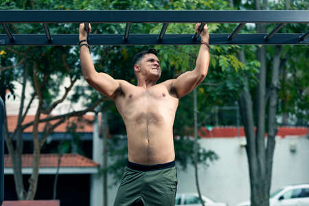 Young man exercising outdoors. Sports lifestyle.