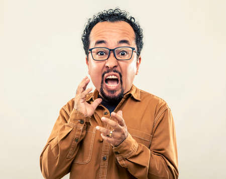expression and people concept - angry man with funny face over gray background (cartoon style character with big head). Adult over 40 years of age.の写真素材