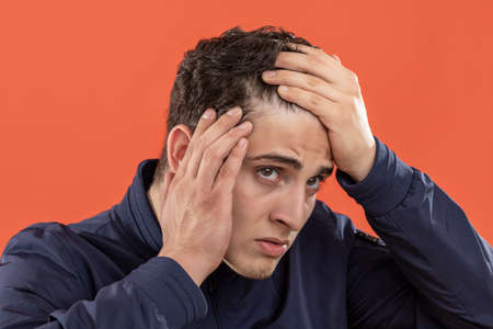 expression and people concept - Young man surprised to discover alopecia problems over...