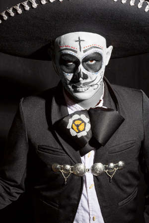 Man with arms crossed and challenging look with charro suit smoking