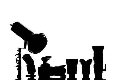 Professional photographic equipment with digital camera, lenses and accessories. black and white Silhouettes back light.の写真素材
