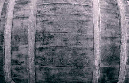 Wine barrels stacked in the old cellar of the winery.