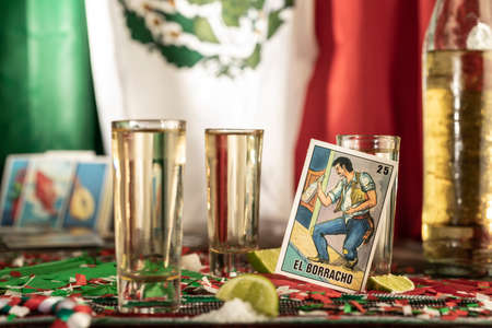 detail of tequila shot on a wood table with mexican decoration. Chart of the lotteryの写真素材