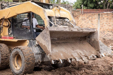 Yellow excavator machine working on during a construction.