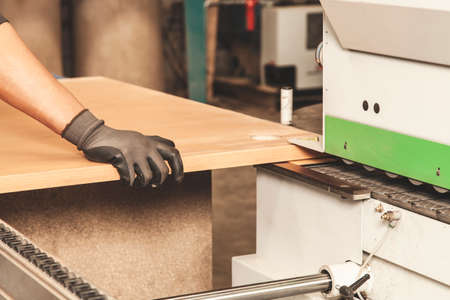 Detail of a carpenter working the wood in workshopの写真素材