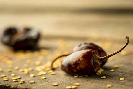 Texture detail of a many red chili peppers in a wooden tableの写真素材