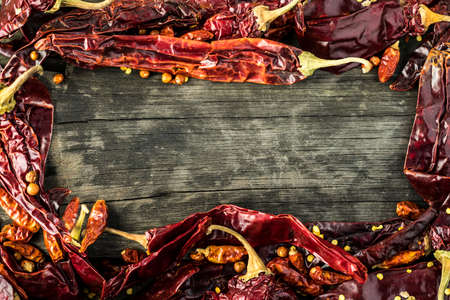 texture detail of a many red chili peppers in a wooden tableの写真素材