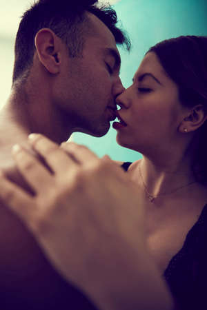 Couple in the privacy of their room, having sex on bedの写真素材