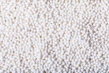 detail of white bowl with quinoa spheres in white background