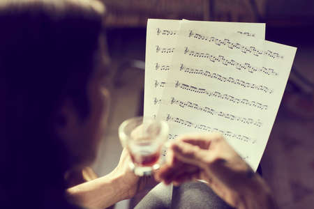 Casual detail indoor of a person reading sheet musicの写真素材