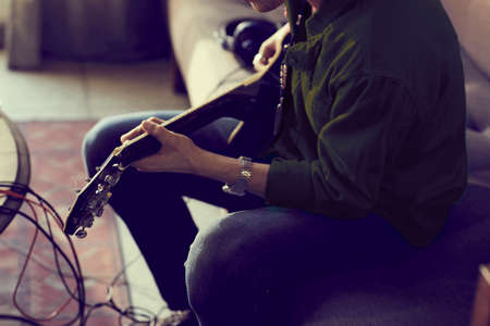 Detail inside of musician playing guitar in audio studioの写真素材