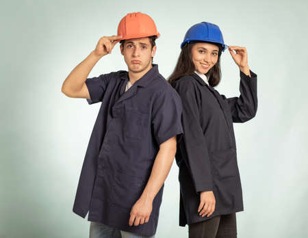 Real mechanic man and woman detail with safety helmetの写真素材