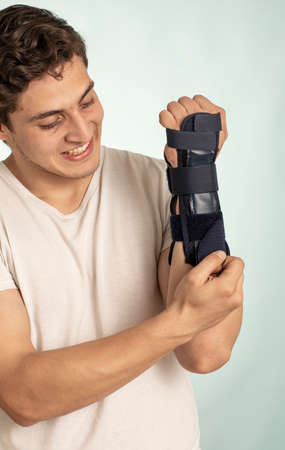 Man hand with adjustable immobilizer for injuries of bones and muscles .. Orthopedic device.human,...