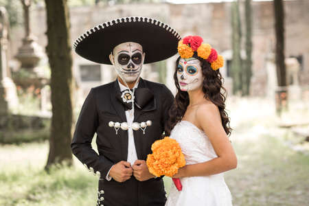 Catrin and Catrina in cemetery with wedding dresses in an old cemetery of Guadalajara, Mexico.
