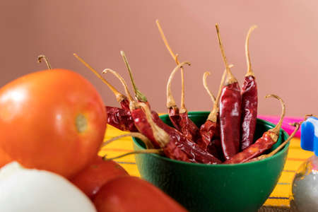 Platon with dried red chilies Typical Mexican food of Guadalajara, rustic table full of sauces and...