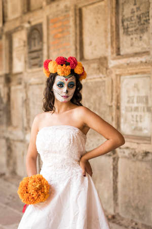 Catrina in cemetery with wedding dresses in an old cemetery of Guadalajara, Mexico.