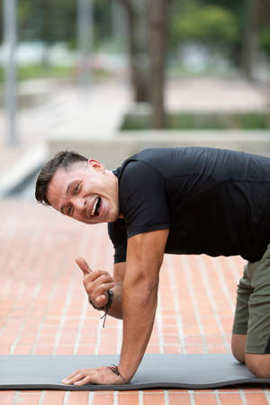 Young and attractive man doing fitness in outdoor parkの写真素材