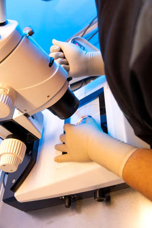 Man Technician in biology managing high-tech laboratory equipment