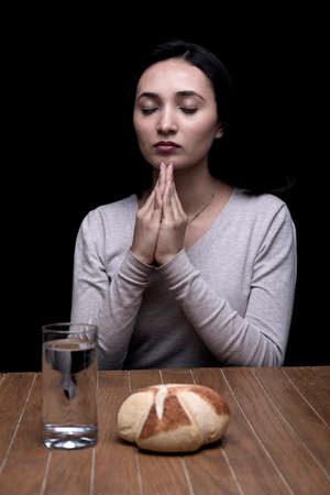 Young woman doing fasting and prayer in an interior
