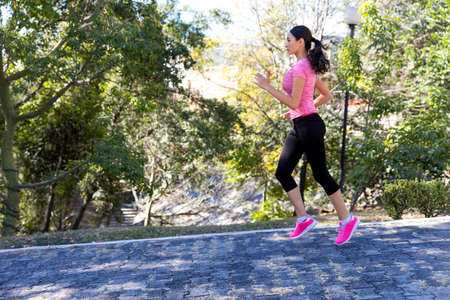 Young and beautiful woman training in outdoors on a sunny dayの写真素材