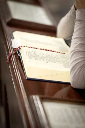 detail Woman praying in a church with bible