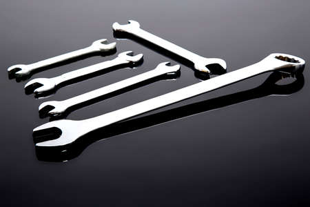 Tools and accessories for the industry on black table. Mechanical keys