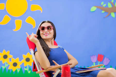 Beautiful woman with glasses dressed in fashion in garden