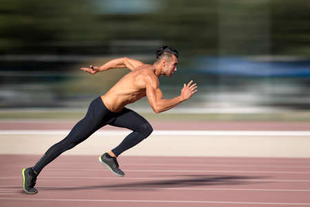 Sprinter leaving on the running track. Explosive start.の写真素材