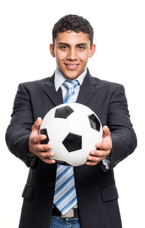 Young executive man smiling with soccer ball in handsの写真素材