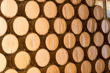 Wine barrels stacked in the old cellar of the winery.の写真素材