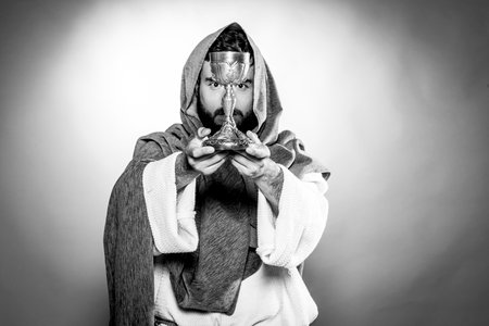Jesus Christ praying to God consecration the bread and grapes in the dark black night. Black and whiteの写真素材