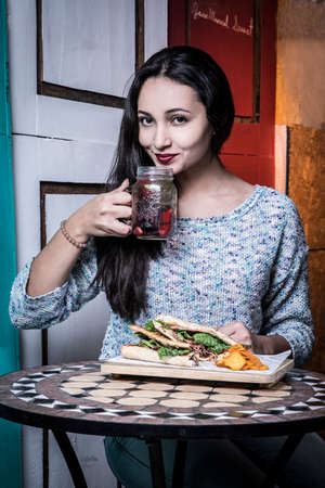 Beautiful woman with smile, eating at old restaurants