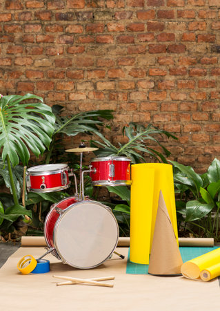 Set of Red drums in garden with plants and colored cardboardの写真素材