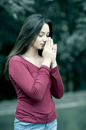 beautiful young woman hands praying in Outdoorsの写真素材