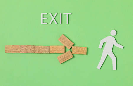 signage made of wooden blocks indicating the exit. on green backgroundの写真素材