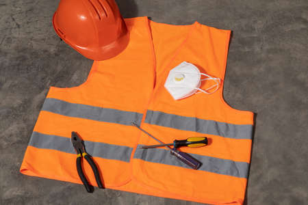 new normality. Dayscene of a construction site uniform and tools on the floor before somebody takes it during COVID-19 pandemic.の写真素材