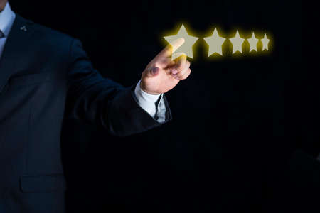 Elegant businessman rating a virtual service with five stars.