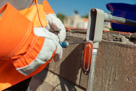 Young electrician fixing the electrical system of a air conditioning. Working hard. Tired manの写真素材