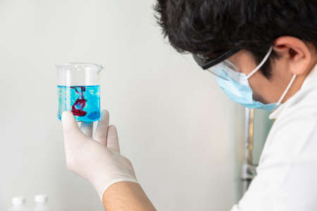 Chemist in his laboratory making chemical solutions on his medical instruments. close upの写真素材