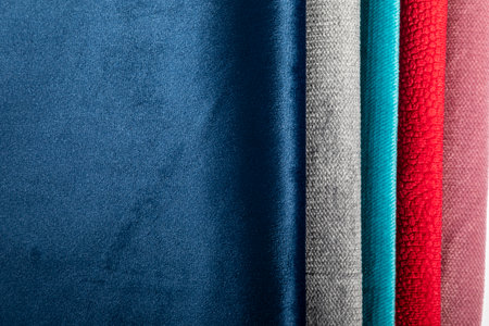 Teddy bear seated indoors with a wooden floor and wall.の写真素材