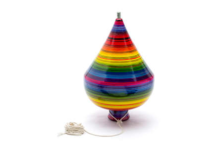 colorful handcrafted wooden spinning top mexican handmade toy on white background.