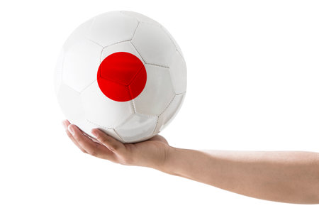 MAN'S HAND SOCCER BALL WITH Japan COUNTRY FLAG ON WHITE BACKGROUND.の写真素材