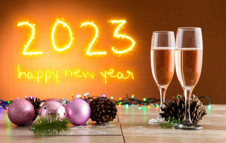 Two glasses with champagne on New Year's Eve party background wishing happy 2023.の写真素材