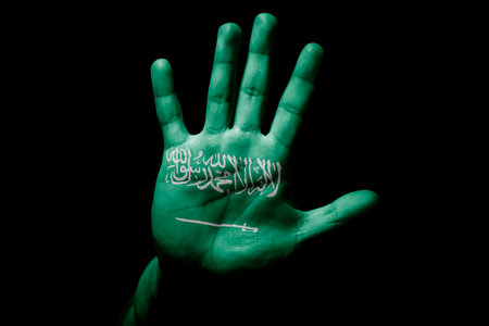 Rude man hand with flag of Saudi Arabia in stop sign to anger, discrimination, racism, abuse on...