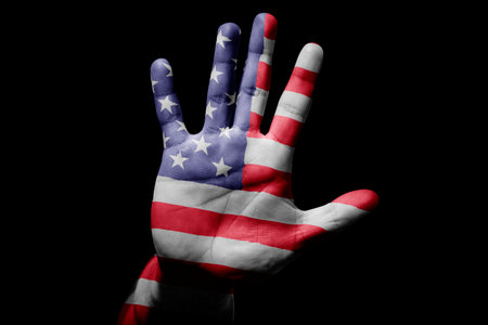 Rude man hand with flag of USA in stop sign to anger, discrimination, racism, abuse on black background.の写真素材