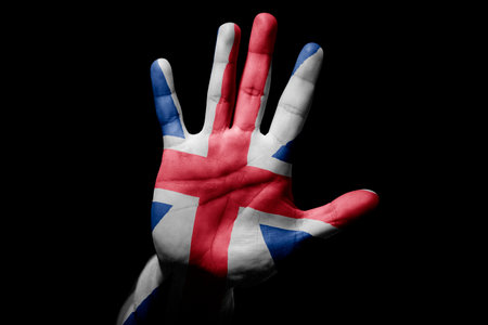 Rude man hand with flag of England in stop sign to anger, discrimination, racism, abuse on black background.の写真素材