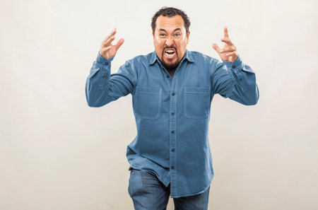 middle aged man in denim topper making multiple expressions and poses on white backgroundの写真素材