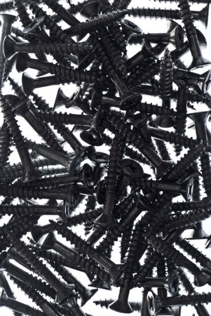 heap of steel construction screws on white backgroundの写真素材