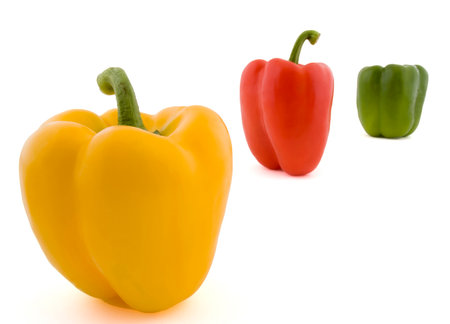 bell peppers of different colors arranged in different ways on white backgroundの写真素材